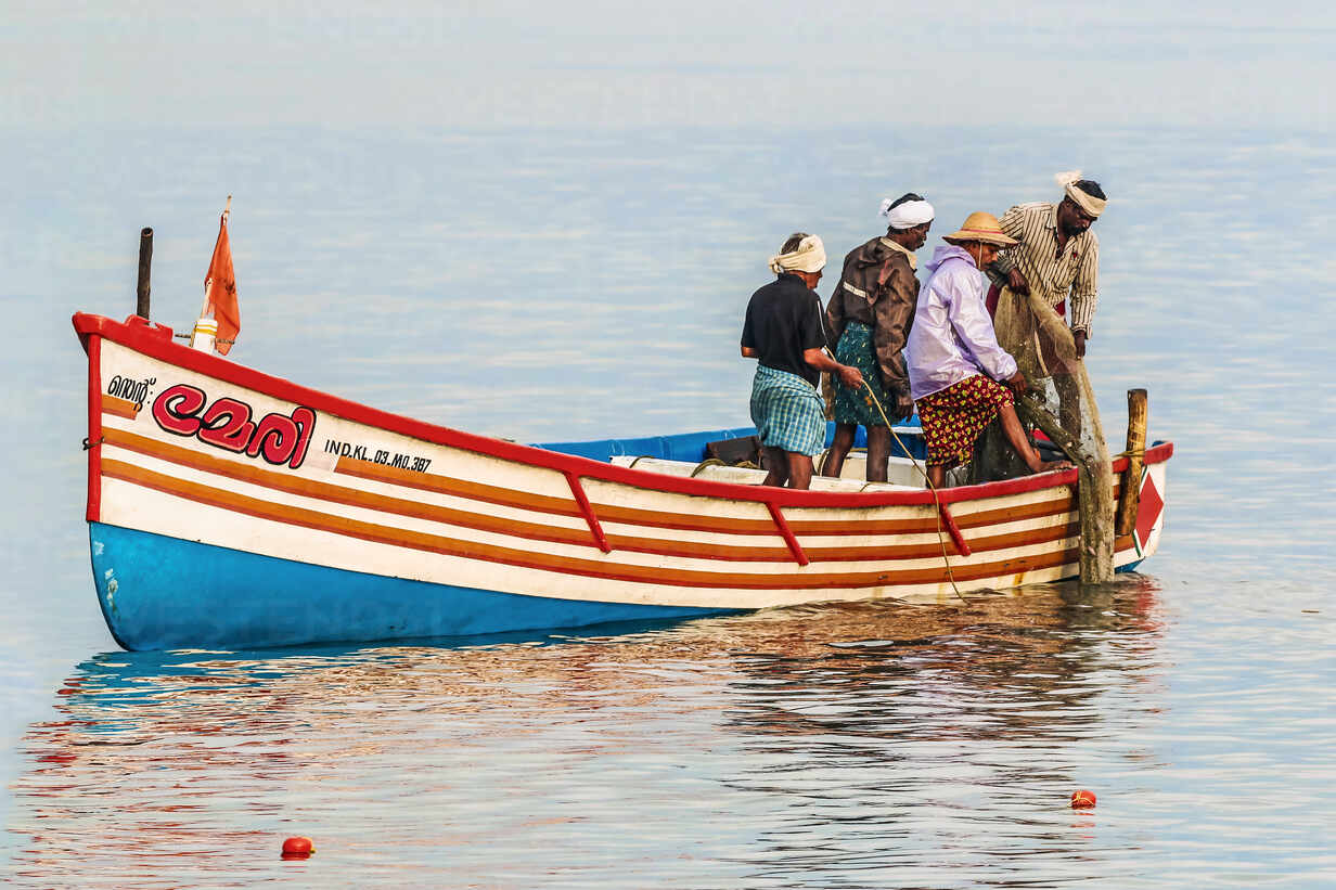 Fishermen pulling in net from the Arabian Ocean just off popular