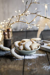 Plate of freshly baked almond cookies with vanilla and powdered sugar - SBDF04340