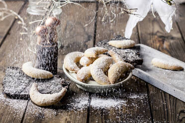 Plate of freshly baked almond cookies with vanilla and powdered sugar - SBDF04341