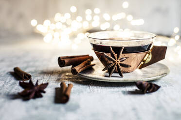 Cup of mulled wine with cinnamon sticks and star anise - SBDF04363