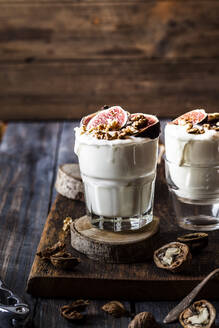 Two glasses of Greek yogurt with honey, figs and walnuts - SBDF04366