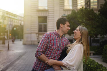 Happy couple standing on street in city - SASF00113