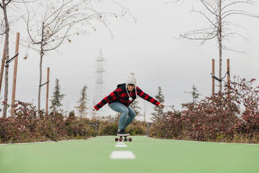 Young woman skateboarding outdoors - MRRF00483