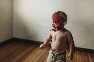 Toddler boy walking in Halloween costume and face mask - CAVF89613