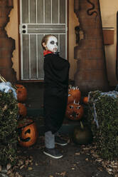 Young boy dressed as Dracula posing in costume at Halloween - CAVF89615