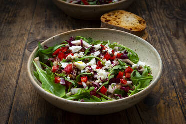 Bowl of vegetable salad with lentils, arugula, red bell pepper, feta cheese and radicchio - LVF09019