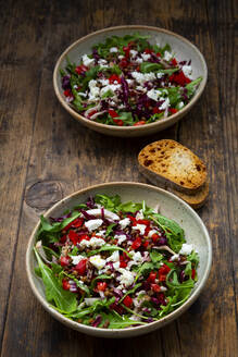 Two bowls of vegetable salad with lentils, arugula, red bell pepper, feta cheese and radicchio - LVF09020