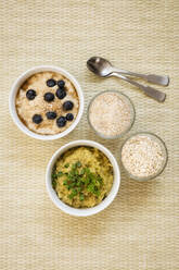 Two bowls of sweet and savory porridge with oats - EVGF03770