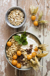 Bowl of porridge with oats, flax seed and winter cherries - EVGF03774