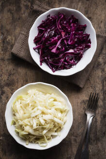 Bowl of red and white cabbage salad on table - EVGF03794