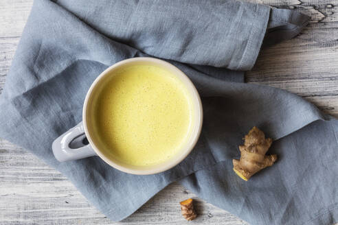 Turmeric milk with ginger and turmeric milk kept on napkin  - EVGF03806