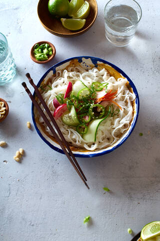 Top view of vegan rice noodle salad made with fresh vegetables, lime and peanut sauce stock photo