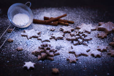 Star shaped cookie with sprinkled flour kept on table - FCF01881