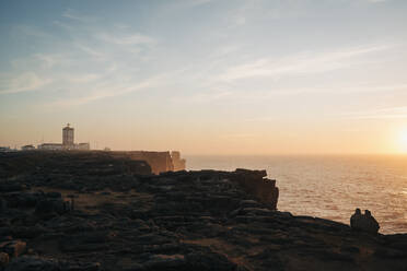 Scenic view lighthouse on cliffs overlooking tranquil seascape at sunset, Peniche, Portugal - FSIF05164