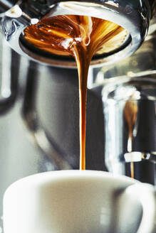 Close up espresso dripping into coffee cup - FSIF05359