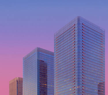 Modern glass skyscraper against sky at dusk, Osaka - LCUF00119