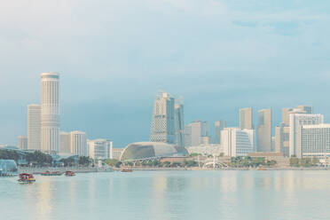 Marina Bay and Esplanade Theater in front of river against blue sky - LCUF00125