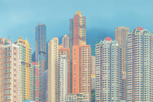 Modern buildings against blue sky in city, Hong Kong - LCUF00127