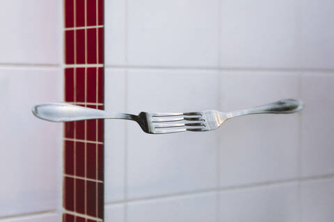 Symmetric reflection of fork on mirror stock photo