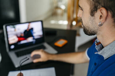 Young man using laptop while studying at home - JRFF04740