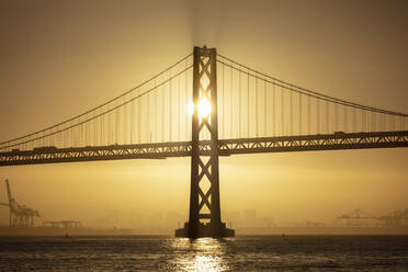 Sunrise behind Oakland Bay Bridge at San Francisco, California, USA - AHF00101