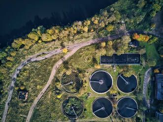 Aerial view of water treatment plant by lake on sunny day - KNTF05606