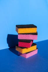 Stack of colorful cleaning sponge on blue background - AFVF07308