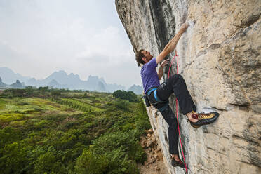 Man climbing on the limestone cliff 