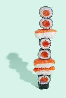 Salmon sushi with nigiri and maki pattern on mint green background - GEMF04194