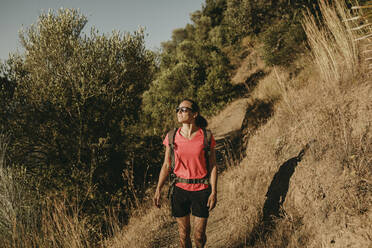 Lächelnde Frau beim Trekking auf einem Berg in der Sierra De Hornachuelos, Cordoba, Spanien - DMGF00161