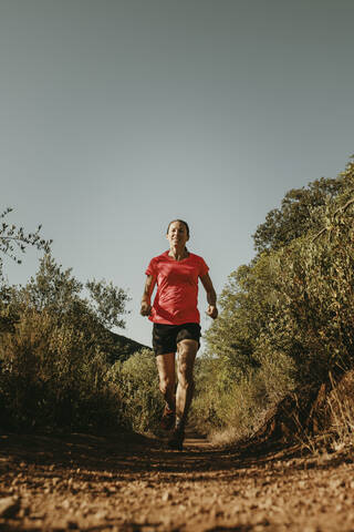 Woman running on footpath at Sierra De Hornachuelos, Cordoba, Spain stock photo