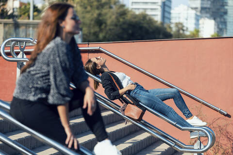 Women relaxing on railing of staircase in city stock photo