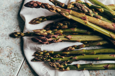 Raw Organic Asparagus Spears, on rustic surface - ADSF16218