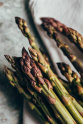 Raw Organic Asparagus Spears, on rustic surface - ADSF16219