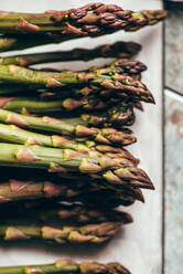 Raw Organic Asparagus Spears, on rustic surface - ADSF16220