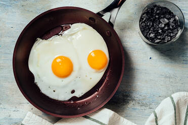 Fried egg. view of two fried eggs on a frying pan. ready to eat with breakfast or lunch - ADSF16229