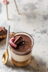 From above of yummy vanilla and chocolate dessert in glass cup decorated with Christmas items - ADSF16272