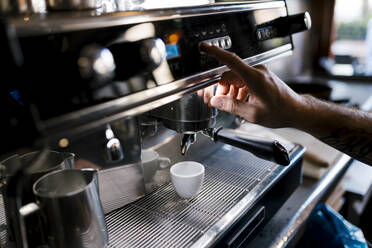 Männlicher Barista bereitet Kaffee in einem Café zu - EGAF00859