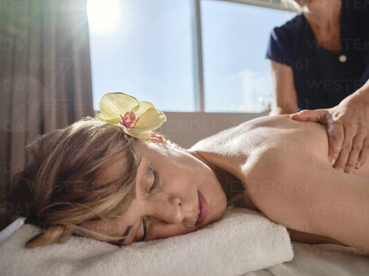 woman giving back massage to a girl Stock Photo