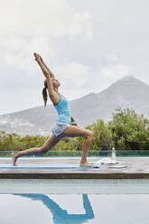 Young woman doing stretching exercise outdoors - RORF02370