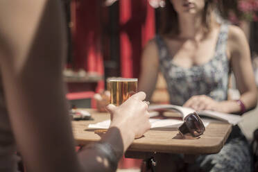 Woman having beer with female friend at pub - AJOF00163
