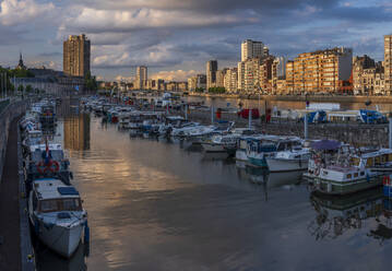 Belgium, Liege Province, Liege, Rows of boats moored along city canal at dusk - HAMF00710