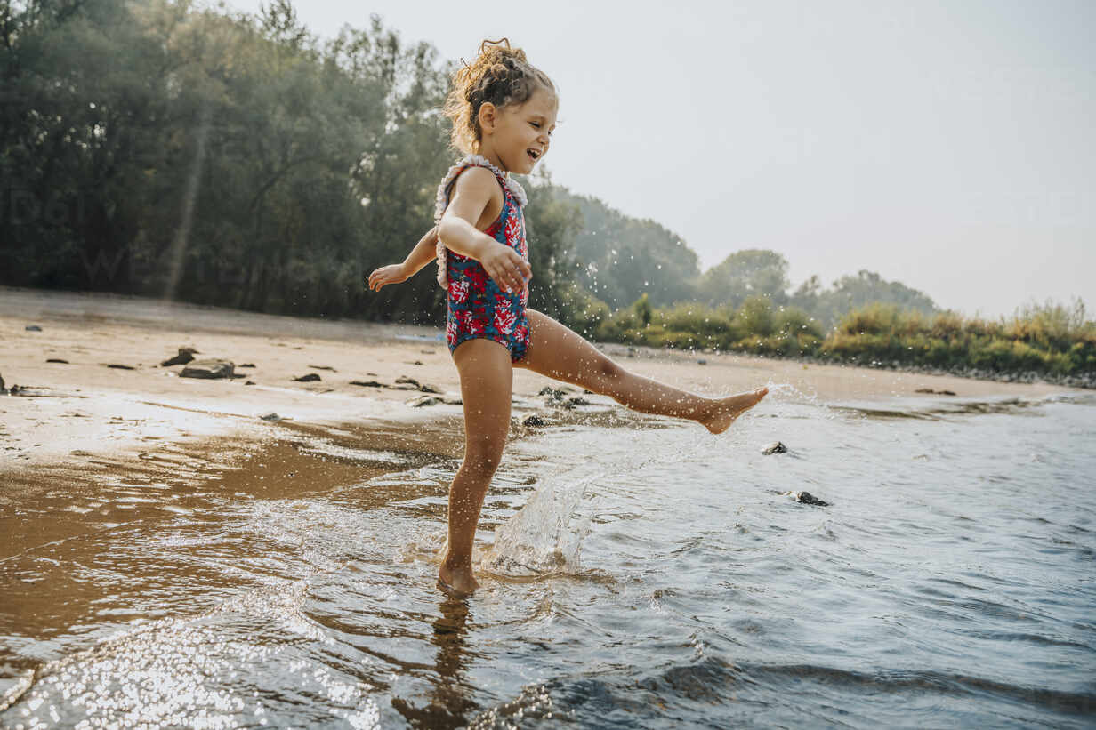 Beautiful little girl swims in the pool , cute little girl in pool in sunny  day.little girl . Stock Photo