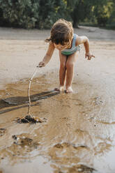 Nettes kleines Mädchen entdeckt für Krabbe am Strand - MFF06275