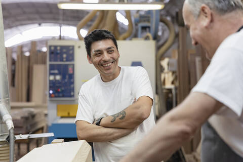 Smiling coworkers working together at workshop stock photo