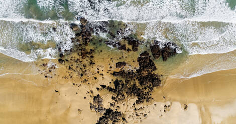 Aerial view of rocks on sandy coastal beach - MGOF04537