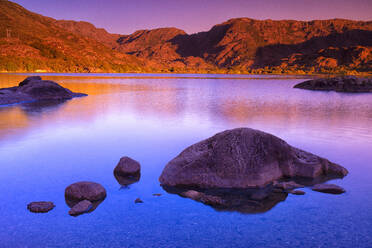 Boulders on shore of Sanabria Lake at dusk - DSGF02256