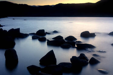 Rocks on shore of Sanabria Lake at dusk - DSGF02257