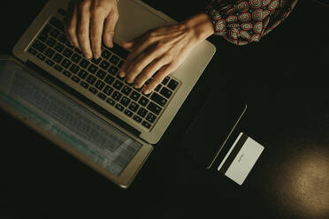 Hands of businesswoman working on laptop in office - DMGF00182