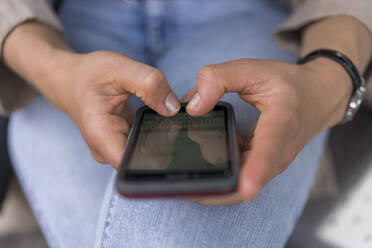 Hands of woman text messaging on smart phone - BOYF01630